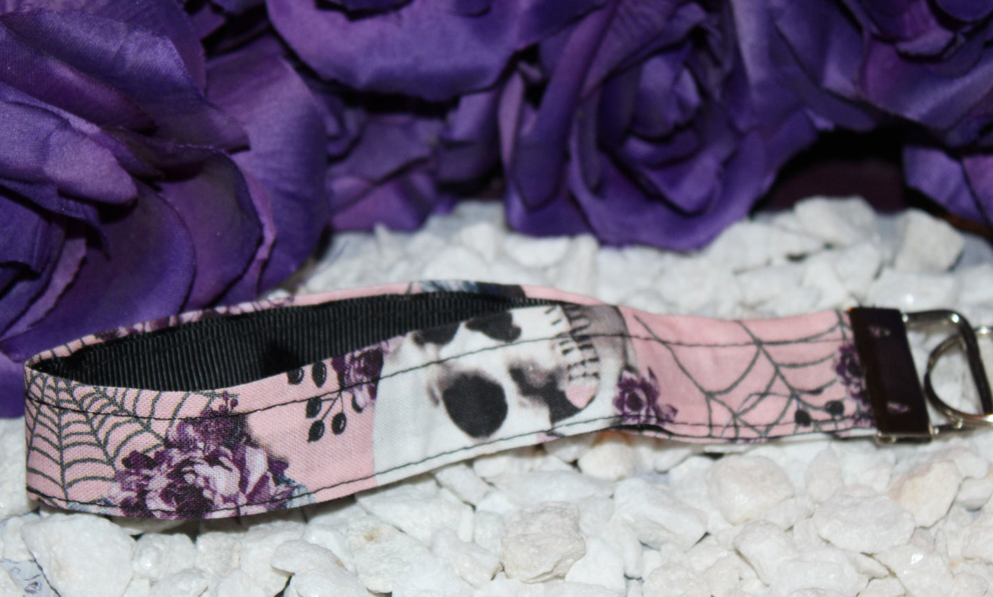 Feminine Skull and Flowers Wristlet Keychain with Pink Background