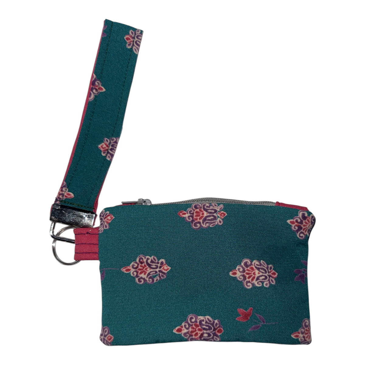 A teal fabric wristlet pouch with a matching wrist strap, decorated with a pink and purple floral pattern, shown on a plain white background.