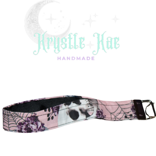 Feminine Skull and Flowers Wristlet Keychain with Pink Background