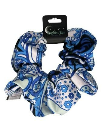 Set of blue and white patterned scrunchies on a white background