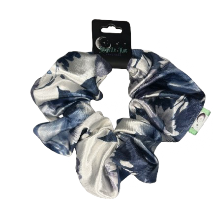 Blue and white patterned scrunchie with packaging on a white background